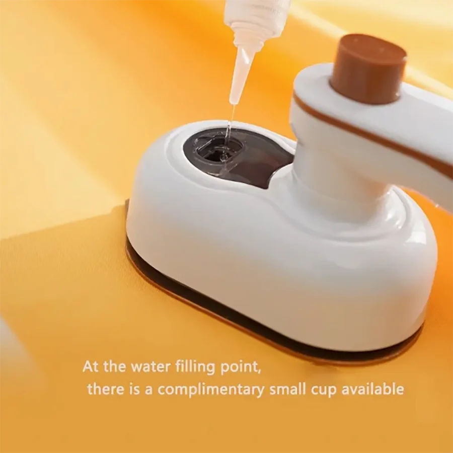 Mini steam iron plugged in and heating up for travel use